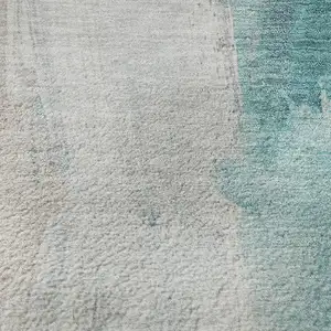 Photo of Teal Khaki And Ivory Abstract Washable Area Rug With UV Protection