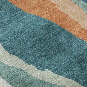Photo of Teal Orange And Ivory Abstract Washable Area Rug With UV Protection