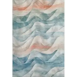 Photo of Teal Peach And Ivory Abstract Washable Area Rug With UV Protection