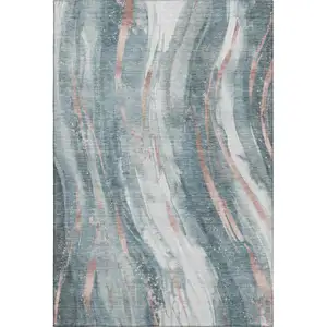 Photo of Teal Peach And Ivory Abstract Washable Area Rug With UV Protection