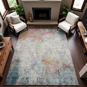 Photo of Teal Pink And Gold Abstract Washable Area Rug With UV Protection