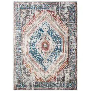 Photo of Teal Taupe and Rust Geometric Distressed Area Rug With Fringe