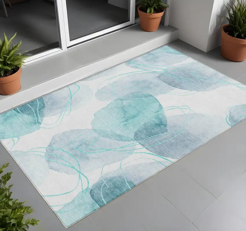 Teal and Ivory Abstract Washable Non Skid Indoor Outdoor Area Rug Photo 1
