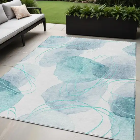 Teal and Ivory Abstract Washable Non Skid Indoor Outdoor Area Rug Photo 1
