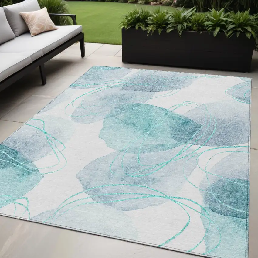 Teal and Ivory Abstract Washable Non Skid Indoor Outdoor Area Rug Photo 1