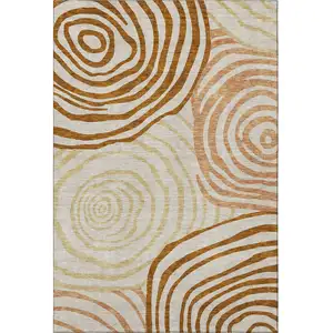 Photo of Terra Cotta Beige And Gold Abstract Washable Area Rug With UV Protection