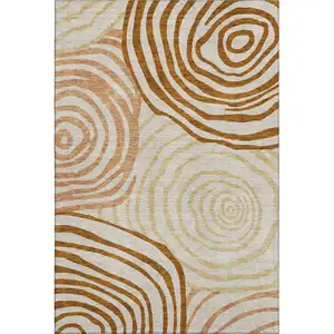 Photo of Terra Cotta Beige And Gold Abstract Washable Area Rug With UV Protection