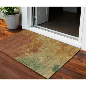 Photo of Terra Cotta Copper And Green Abstract Washable Indoor Outdoor Area Rug