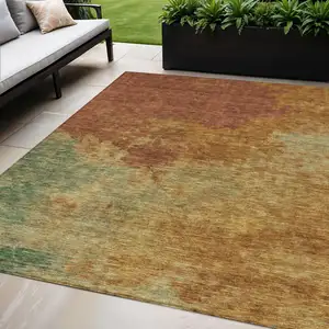 Photo of Terra Cotta Copper And Green Abstract Washable Indoor Outdoor Area Rug