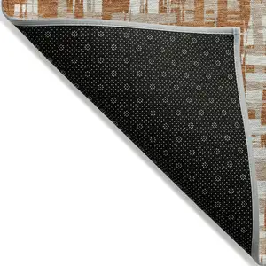 Photo of Terra Cotta Tan And Ivory Abstract Washable Indoor Outdoor Area Rug