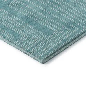 Photo of Turquoise And Ivory Geometric Washable Area Rug With UV Protection