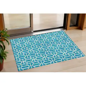 Photo of Turquoise And Ivory Geometric Washable Indoor Outdoor Area Rug