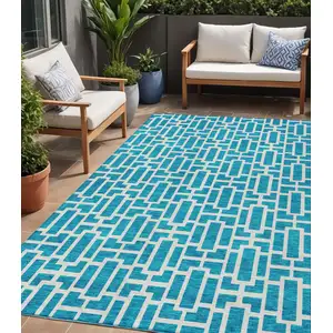 Photo of Turquoise And Ivory Geometric Washable Indoor Outdoor Area Rug