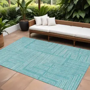 Photo of Turquoise And Ivory Geometric Washable Indoor Outdoor Area Rug