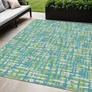 Photo of Turquoise Green And Ivory Abstract Washable Indoor Outdoor Area Rug