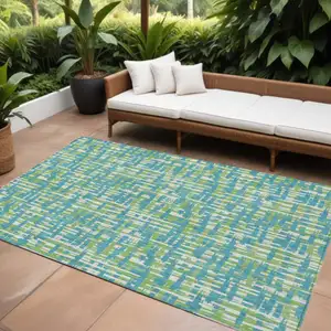 Photo of Turquoise Green And Ivory Abstract Washable Indoor Outdoor Area Rug