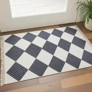 Photo of White And Black Diamond Area Rug With Fringe