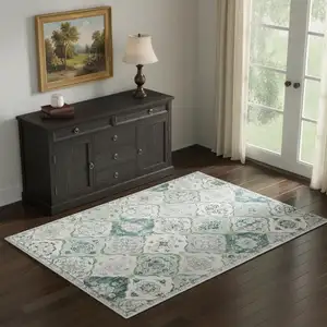 Photo of White Teal And Sage Quatrefoil Distressed Area Rug