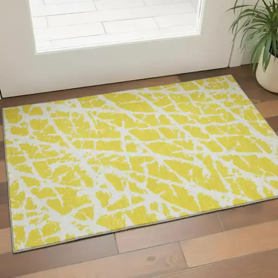 Yellow And Ivory Abstract Washable Area Rug With UV Protection Photo 1