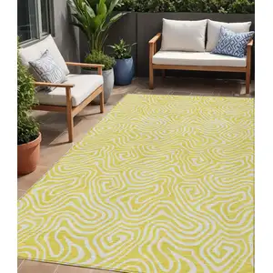 Photo of Yellow And Ivory Abstract Washable Indoor Outdoor Area Rug