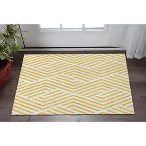 Photo of Yellow And Ivory Geometric Washable Area Rug With UV Protection